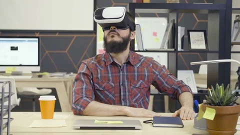 Creative bearded man uses virtual reality glasses Stock Footage 72549116