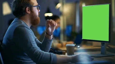 Creative Bearded Man Works on a Computer with Isolated Mock-up Green Screen. Stock Footage 79446376