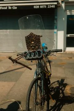 Creative bicycle with shield emblem, sticks, and windshield parked on street Stock Photos