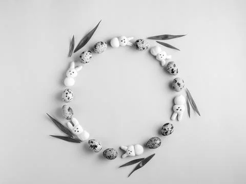 Creative black and white Easter wreath from motley quail eggs, marshmallow bu Stock Photos