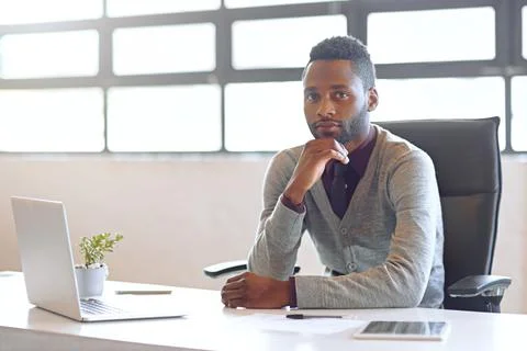 Creative, black man and technology on desk in office for work as web developer Stockfoto's