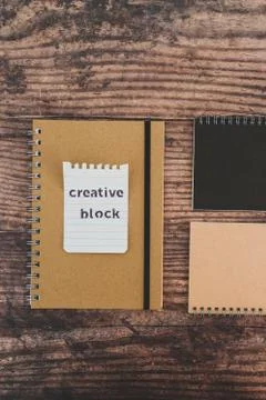 Creative block or writer's block, notepads on wooden desk with text doodle on Stock Photos