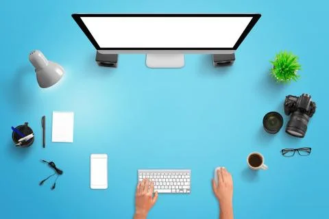 Creative blue studio desk with computer display, mobile phone, camera, lens,  스톡 사진
