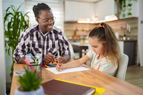 Creative bonding moment between a mentor and child at home Stock Photos