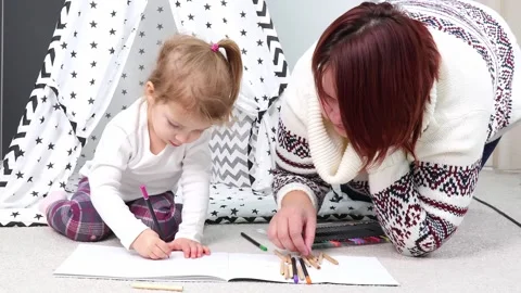 Creative bonding time with a child in a cozy home setting 스톡 동영상 295354269