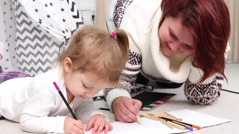 Creative bonding time with a child in a cozy home setting 스톡 동영상 295354572