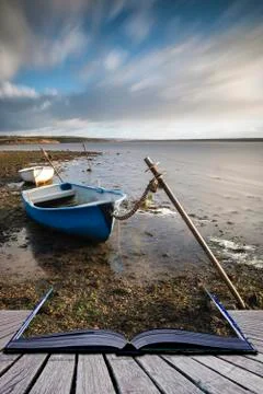 Creative book image of Beautiful vibrant sunset landscape image of boats moor Stock-Fotos