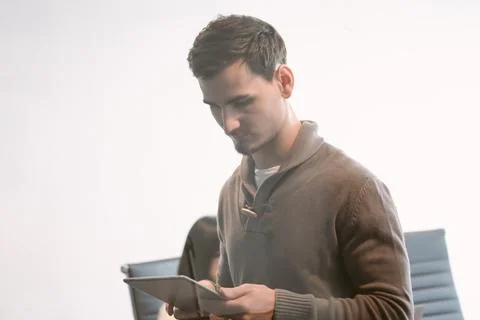 Creative business man using digital tablet work standing in office Stock Photos