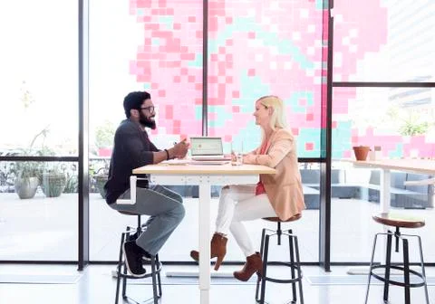 Creative business people talking at table with laptop Stock Photos