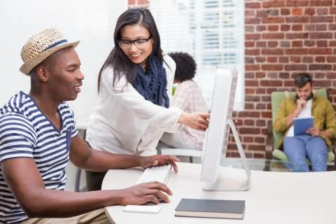 Creative business people using computer Stock Photos
