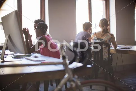 Creative business people working in open office plan Stock Photos