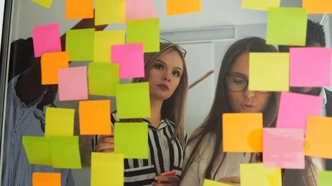 Creative business team brainstorming ideas working together sharing data late at Stock Footage 88555829
