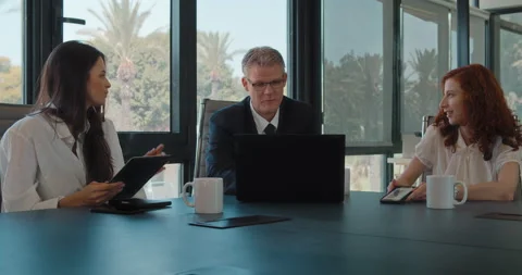 The creative business team of three people discussing a new project. Stock Footage 139916373