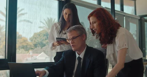 The creative business team of three people discussing a new project. Stock Footage 139920004