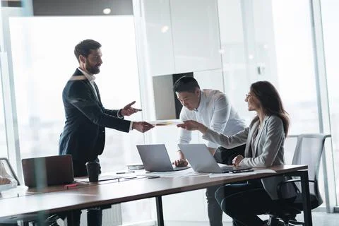 Creative business team working on project in modern office with panoramic view Stock Photos