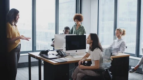 Creative business team working together and talking in a busy casual office, 스톡 동영상 111928382