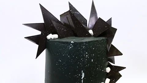 Creative cake in black design with chocolate spikes, decorated with marshmallows Stock Footage 150166499