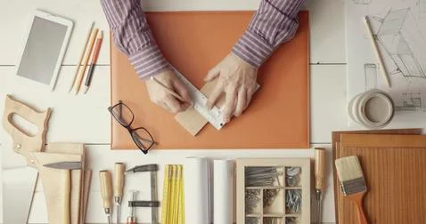 Creative carpenter and designer working at desk Stock Photos