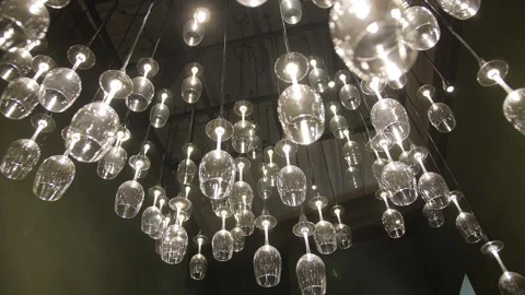 Creative chandelier in wineglasses shape decorates ceiling Stock Footage 194227490