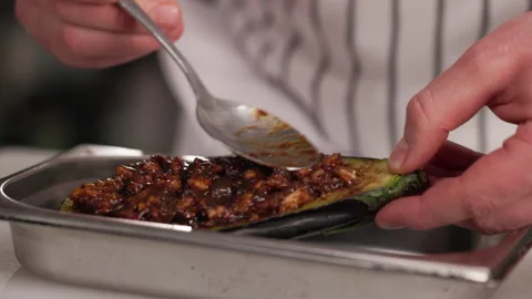 Creative chef applying sauce on grilled eggplant with spoon Stock Footage 274501264