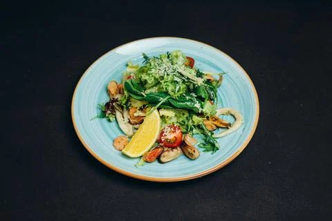 The creative chef made a new dish in the plate and placed it on the black t.. Stock Photos