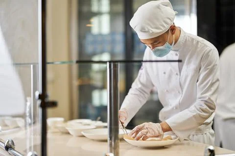 Creative chef preparing fancy meals for guests to enjoy Stock Photos