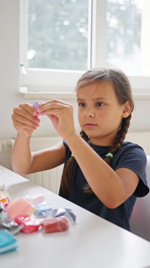 A Creative Child Engaging in an Exciting Play Session with Colorful Crafting Stock Footage 314619033