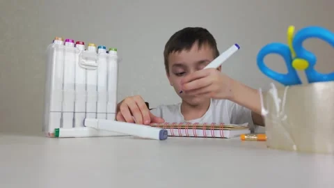 A Creative Child Fully Engaged in Art Activities Using Colorful Markers and Stock Footage 302184642