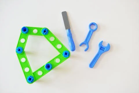 Creative children's constructor with children's tools: otvetka, file, wrench. Stock Photos