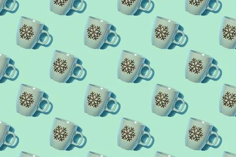 Creative Christmas pattern. Empty cup with snowflake pattern on light green b Foto stock