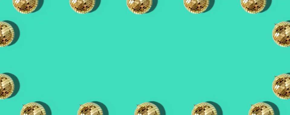 Creative Christmas pattern. Frame with shiny gold disco balls over mint Stock Photos
