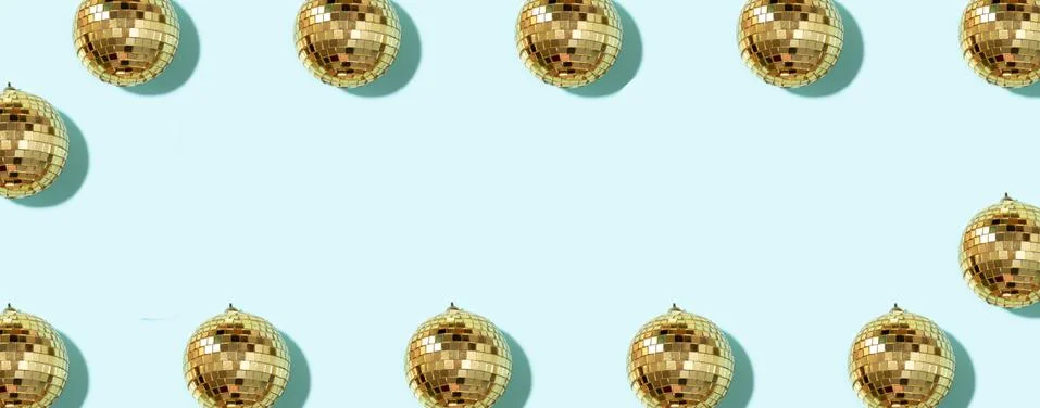 Creative Christmas pattern. Frame with shiny gold disco balls over blue Stock Photos
