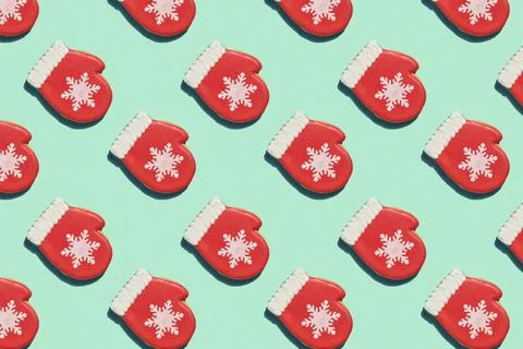Creative Christmas pattern. Red mitten with snowflake over light green backgr Foto stock