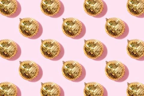 Creative Christmas pattern. Shiny gold disco balls over pink background. Flat Stock Photos