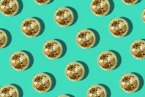 Creative Christmas pattern. Shiny gold disco balls over mint background. Flat Stock Photos