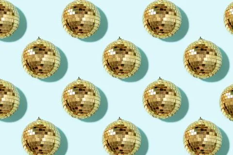 Creative Christmas pattern. Shiny gold disco balls over blue background. Flat Stock Photos