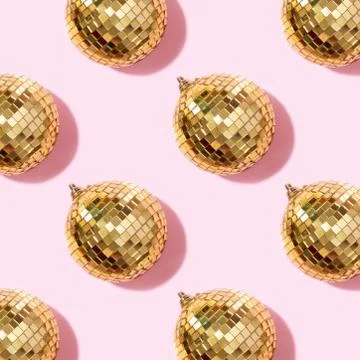 Creative Christmas pattern. Shiny gold disco balls over pink background. Flat Stock Photos