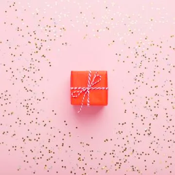Creative Christmas present in small red box on pink Stock Photos