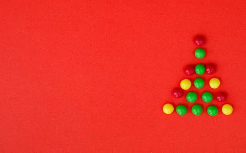 Creative Christmas tree made of different colours candies dragee Stock Photos
