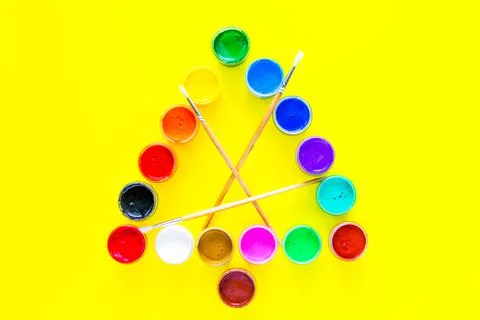 Creative Christmas tree made of paint cans with tassels in the center on a Stock Photos
