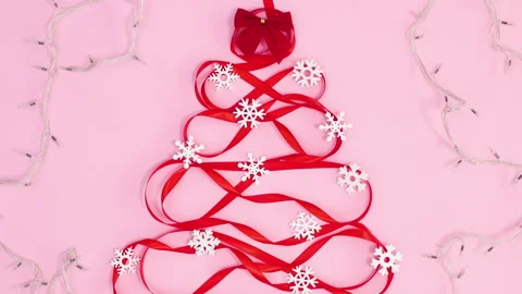Creative Christmas tree shape made of red ribbon with lights. Stop motion Stock Footage 162005386