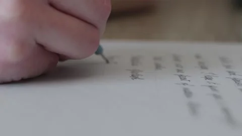 Creative cinematic shot of a completed handwritten letter on book page Stock Footage 336300342