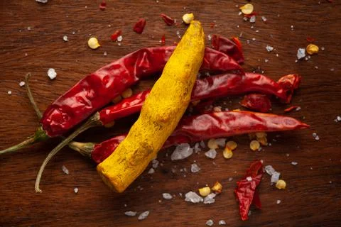 Creative close-up composition of red Chili pepper and dry yellow turmeric roo 스톡 사진
