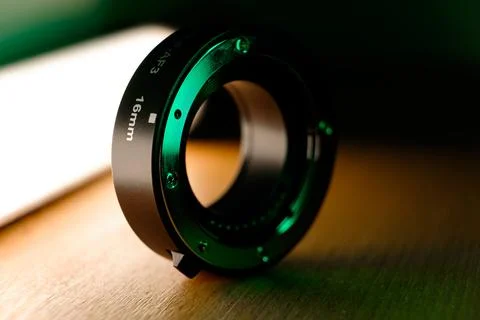 Creative close-up of a professional camera lens adapter on a textured surface Photos