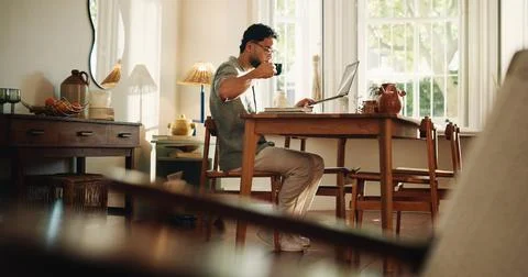 Creative, coffee and man with laptop, home and research for logo design on .. Stock Photos