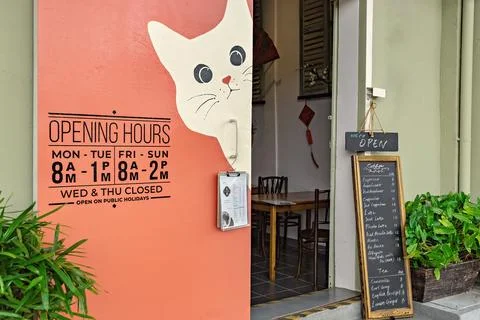 Creative coffee shop with cat logo and coffee menu at the entrance Stock Photos