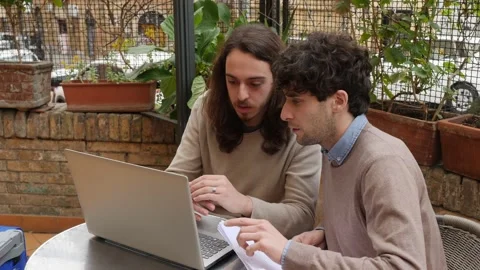 Creative collaboration -young creatives intent on writing a screenplay on the pc Stock Footage 220488328