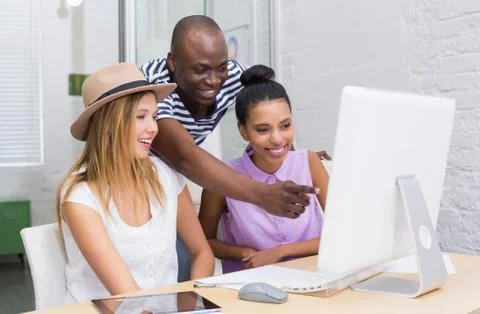 Creative colleagues using computer in meeting Stock Photos