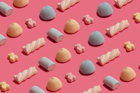 Creative colorful pattern made of fluffy candy, gummy bears and murshmallows  Stock Photos