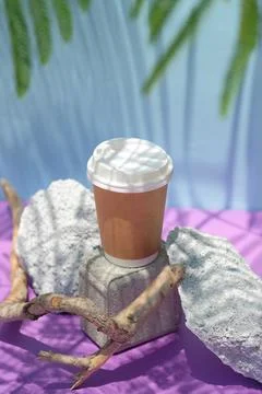 Creative composition from brown craft paper takeaway coffee cup on natural st Stock Photos